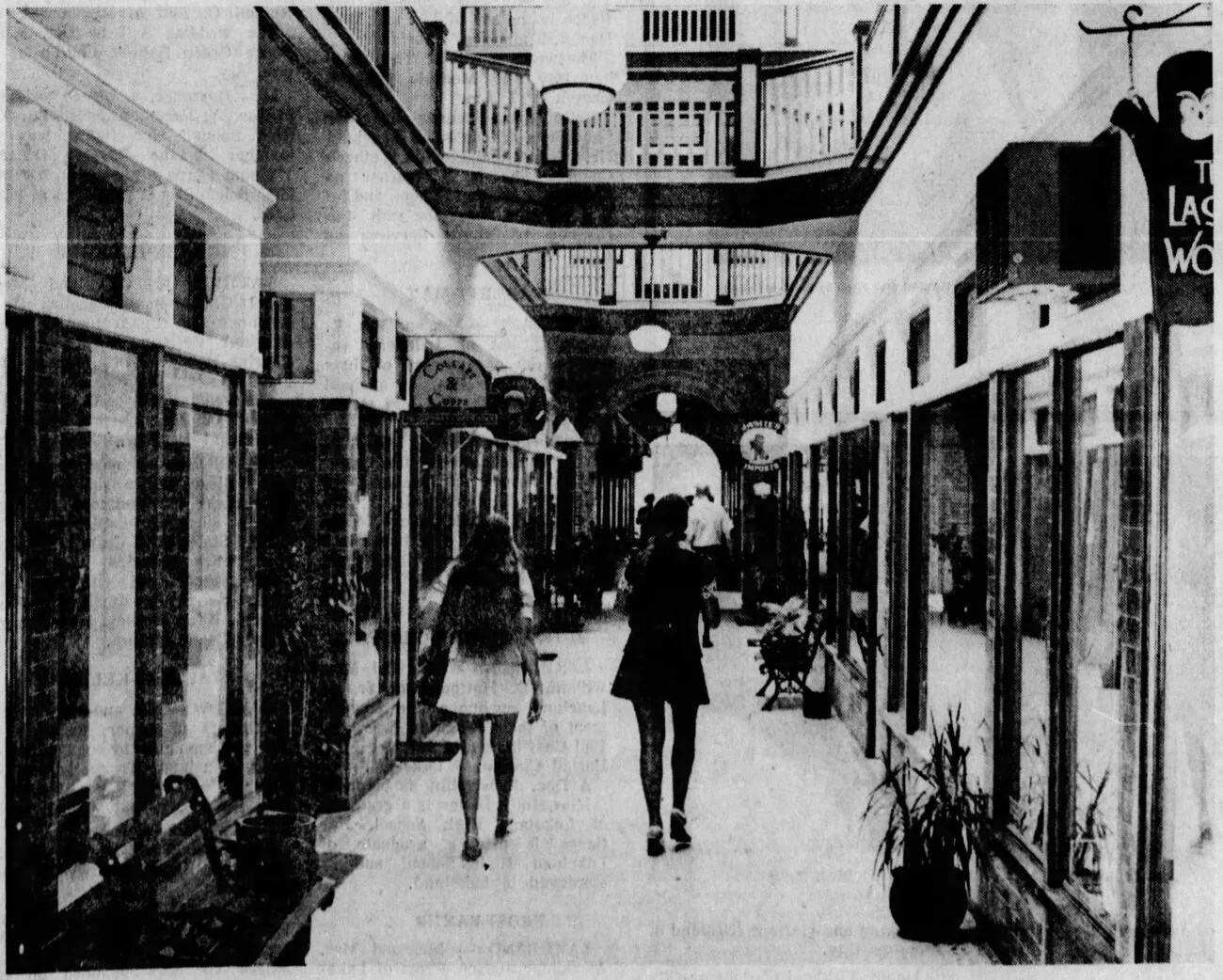Archival photograph of shoppers walking the Rhodesbilt Arcade's interior passage and balconies